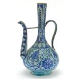 Middle Eastern Iznik style porcelain coffee pot hand painted with flowers amongst foliage, 26cm high