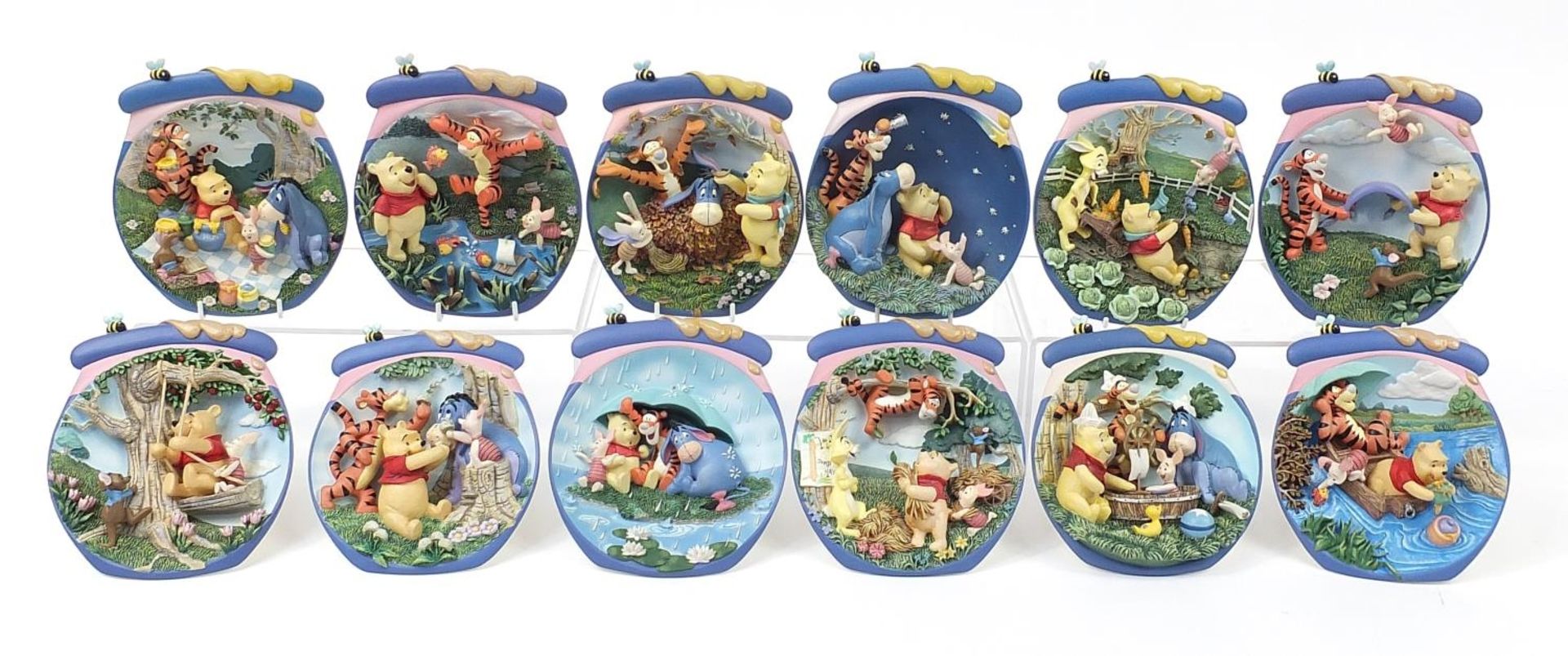Set of twelve Winnie the Pooh collector's wall plaques by The Bradford Exchange, 17cm high