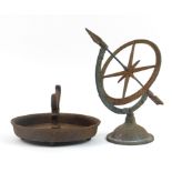 Victorian cast iron boot scraper and a painted metal sundial, the largest 35cm high