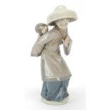 Lladro figurine of a female with child on her back, 26cm high