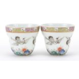 Pair of Chinese porcelain tea cups, each hand painted with cranes above crashing waves, iron red