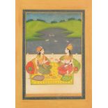 Two seated females before a landscape, Indian Mughal school watercolour on card, mounted,