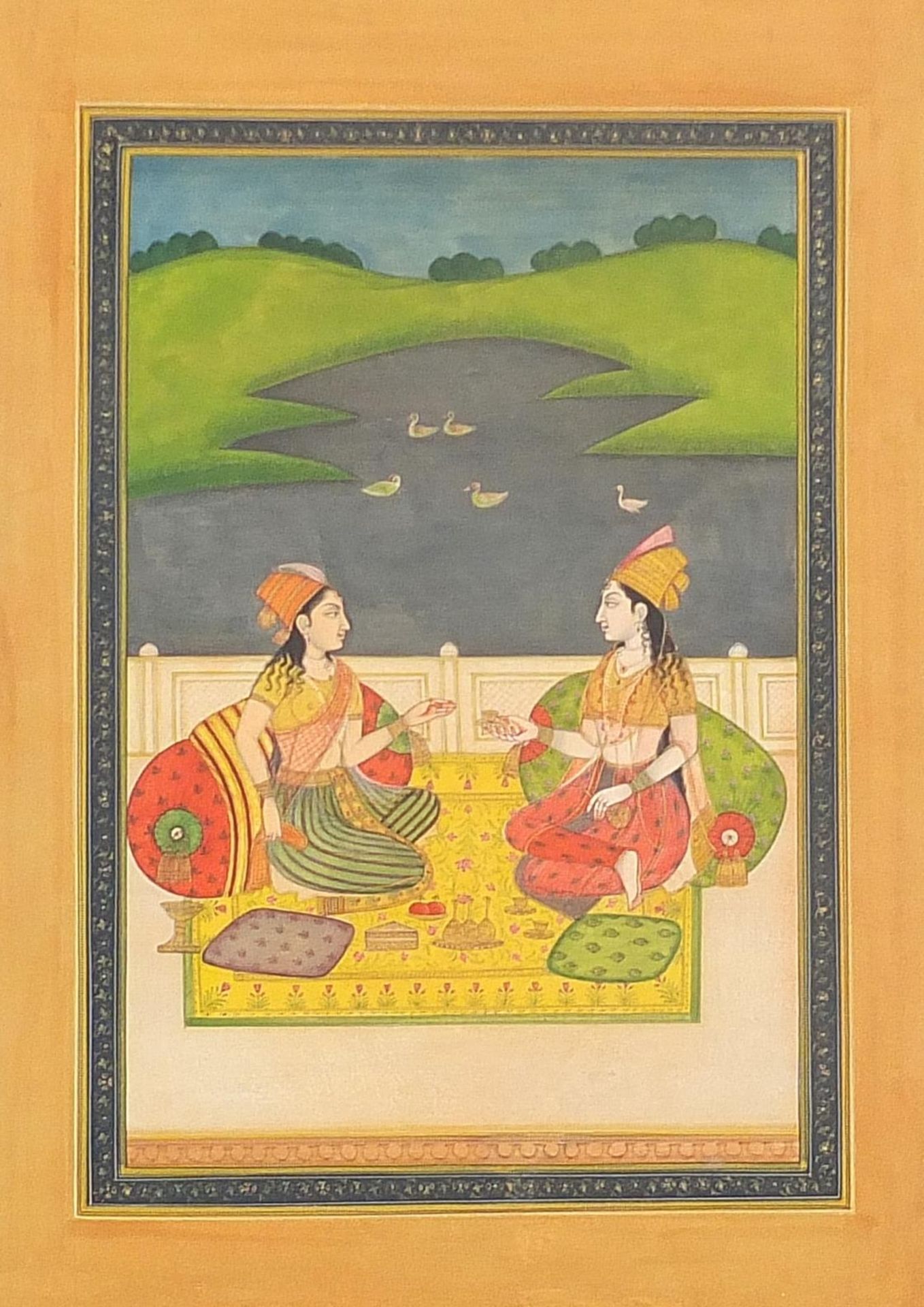 Two seated females before a landscape, Indian Mughal school watercolour on card, mounted,