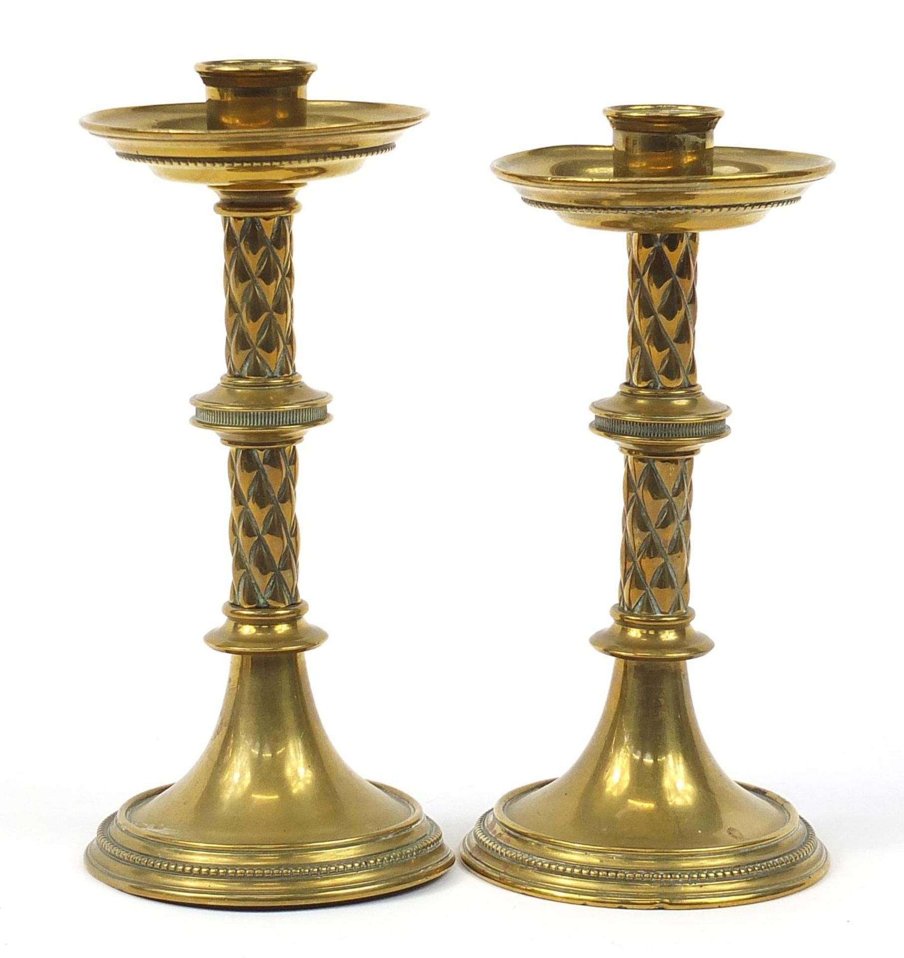 Two Arts & Crafts brass candlesticks by William Tonkin & Son, the largest 21.5cm high