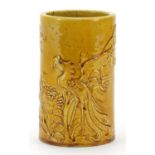Chinese porcelain brush pot having a yellow glaze, decorated in low relief with a phoenix amongst