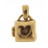 9ct gold love heart handbag charm opening to reveal a diamond, 1.4cm high, 1.1g