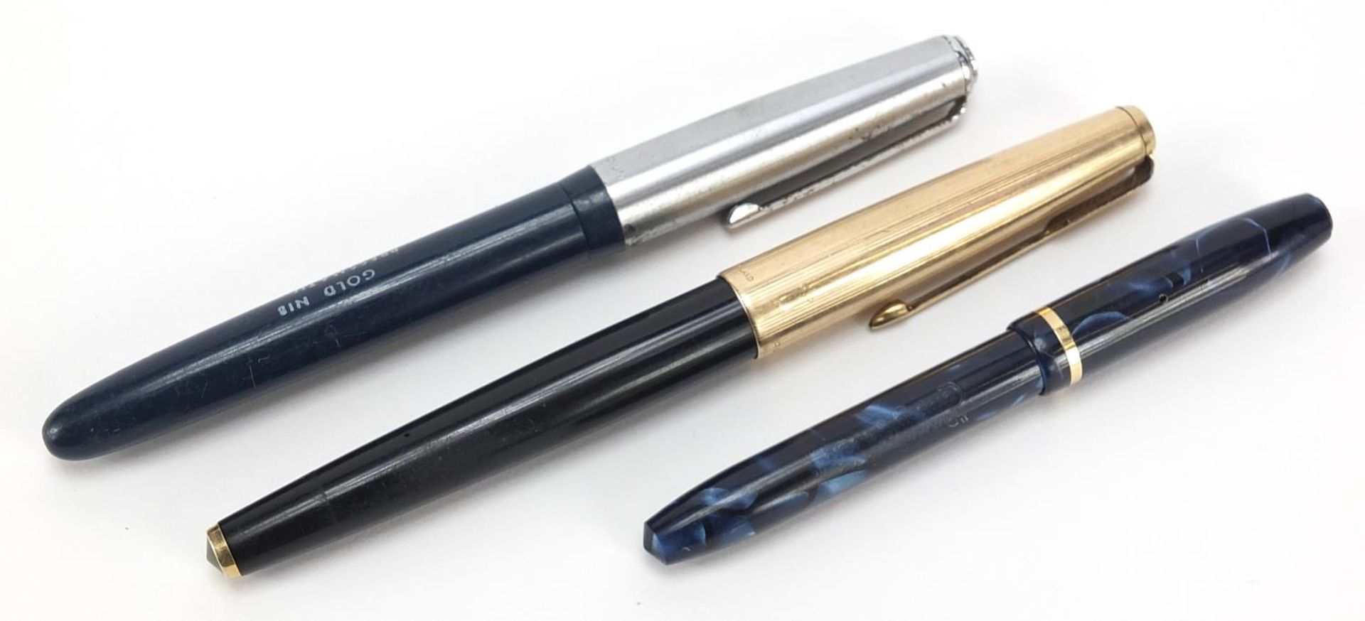 Three vintage Parker and Conway Stewart fountain pens including a blue marbleised example