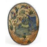 Persian oval pottery tile hand painted with a figure, 36cm high