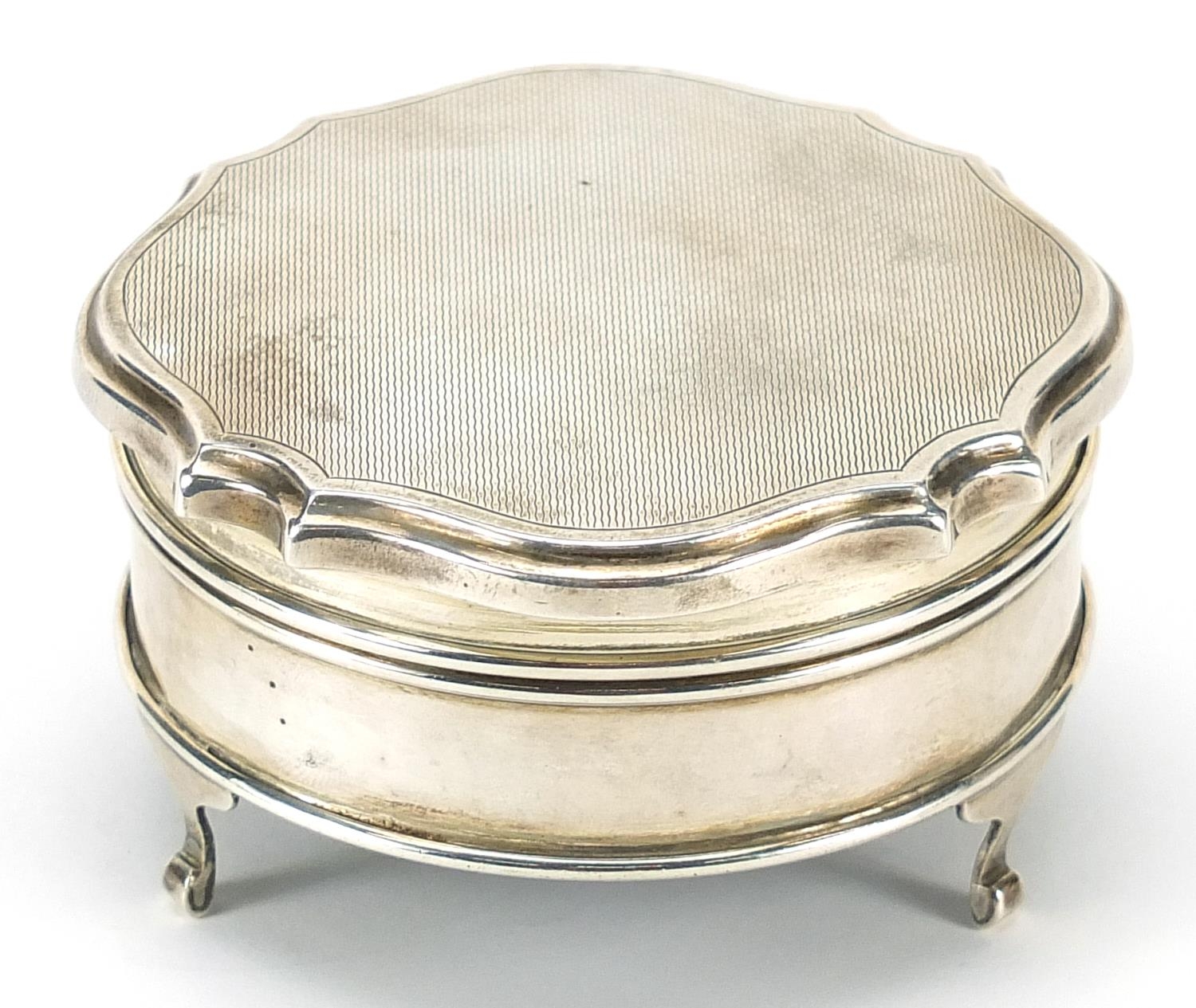 Elizabeth II circular silver jewel box with hinged lid raised on three feet, indistinct maker's mark