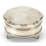 Elizabeth II circular silver jewel box with hinged lid raised on three feet, indistinct maker's mark