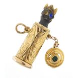 9ct gold jack in the box design charm with spring loaded figure, the lid set with a cabochon green