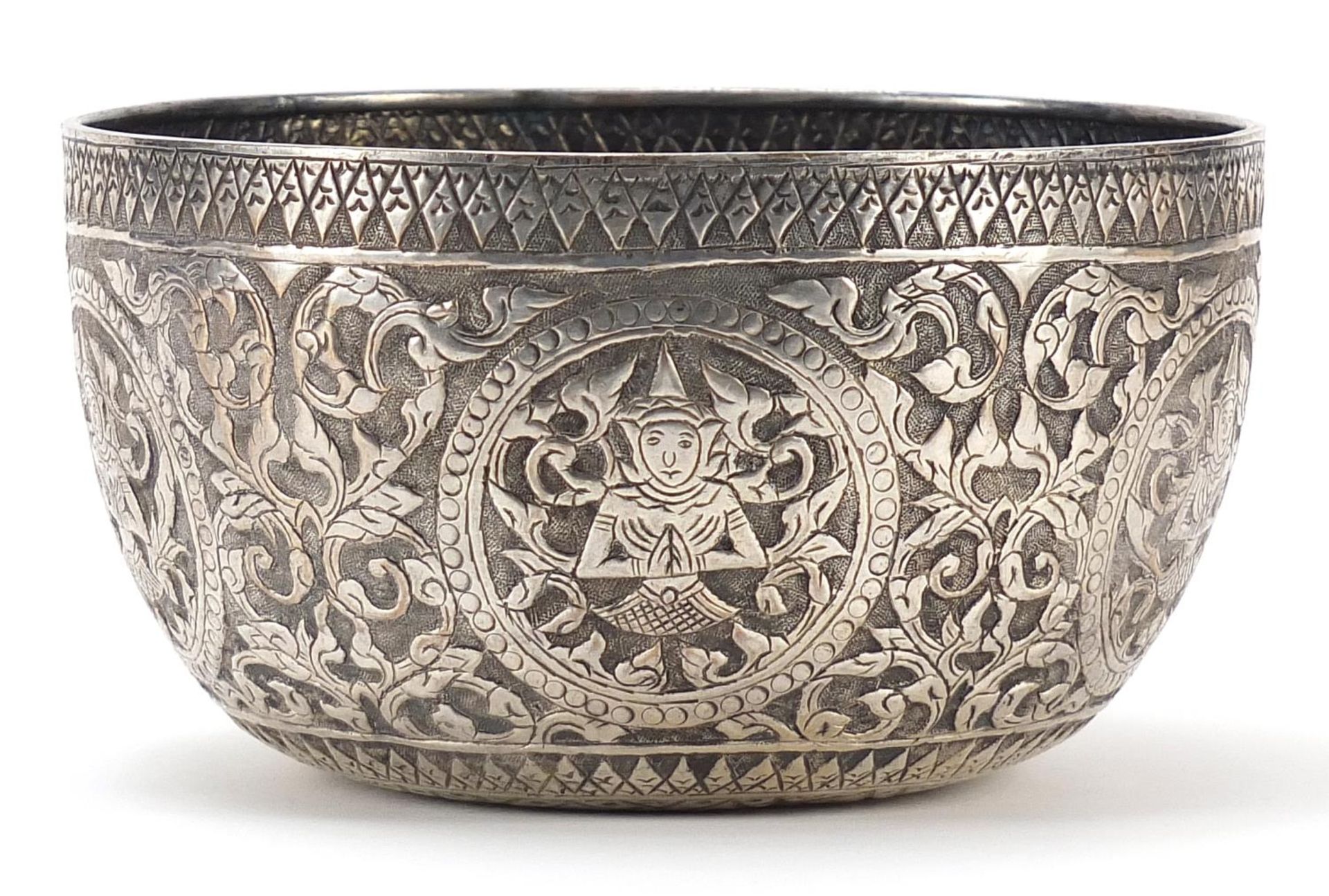 Thai silver coloured metal bowl embossed with deities amongst flowers, 15.5cm in diameter, 111g