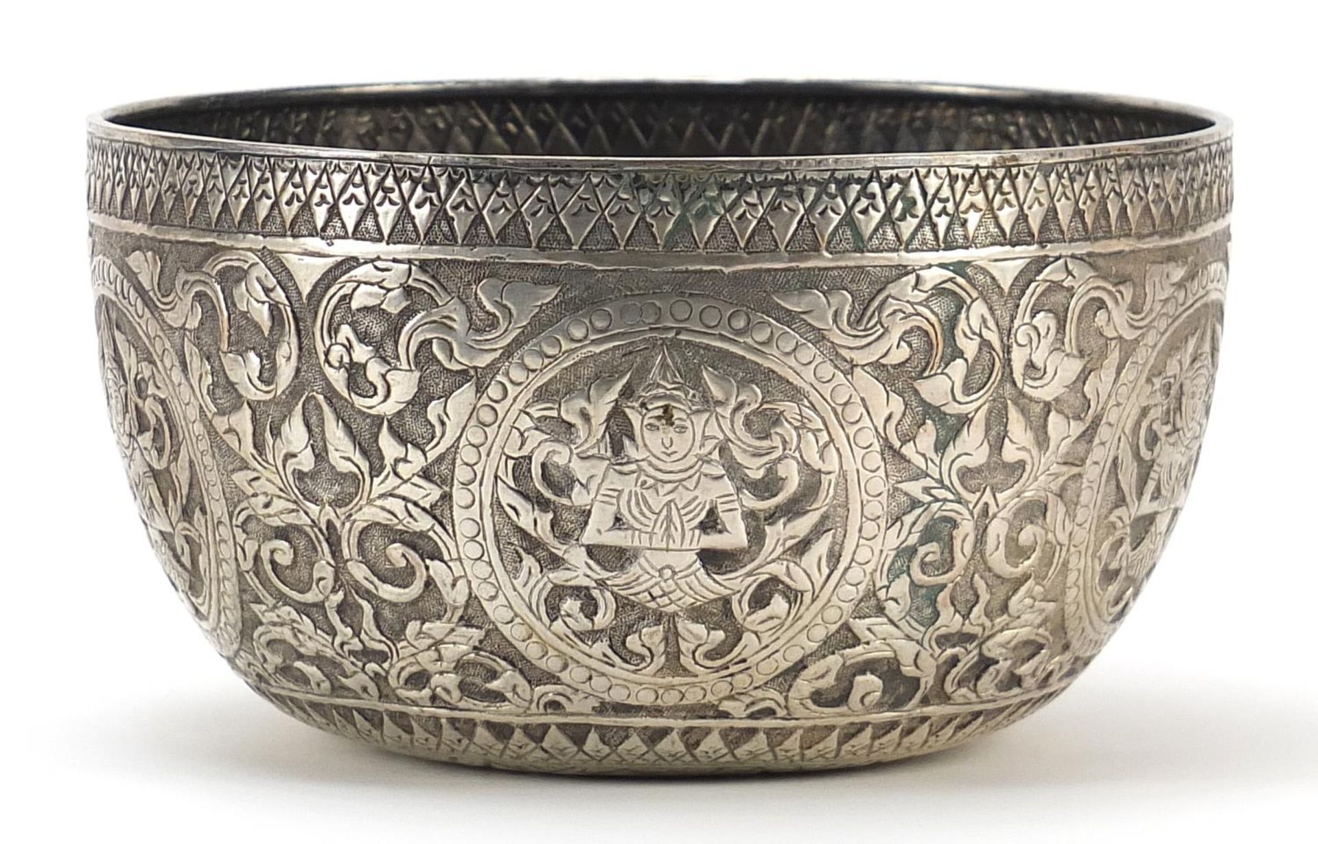 Thai silver coloured metal bowl embossed with deities amongst flowers, 15.5cm in diameter, 111g - Image 2 of 3