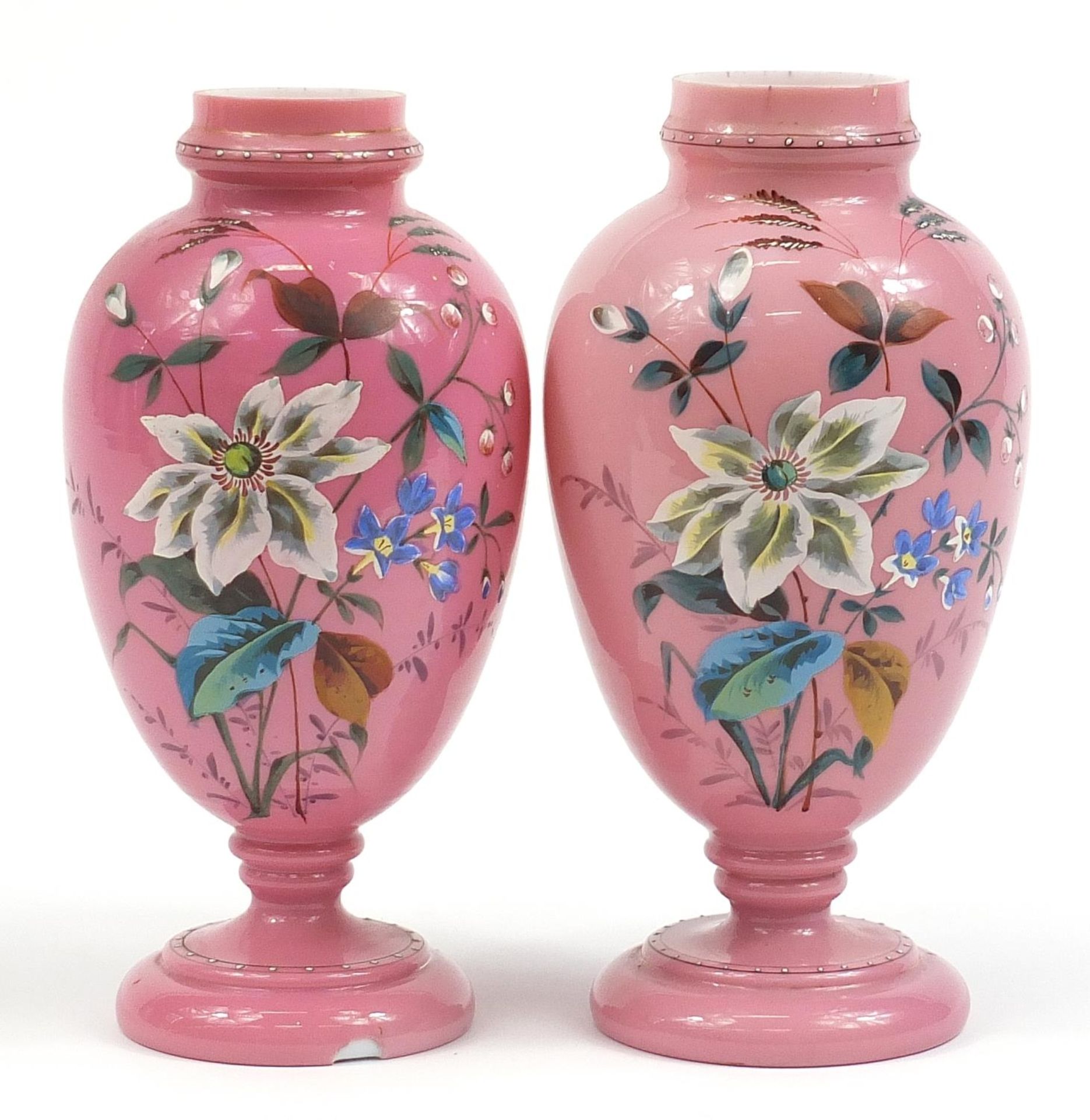 Pair of Victorian pink overlaid glass vases enamelled with flowers, each 28cm high