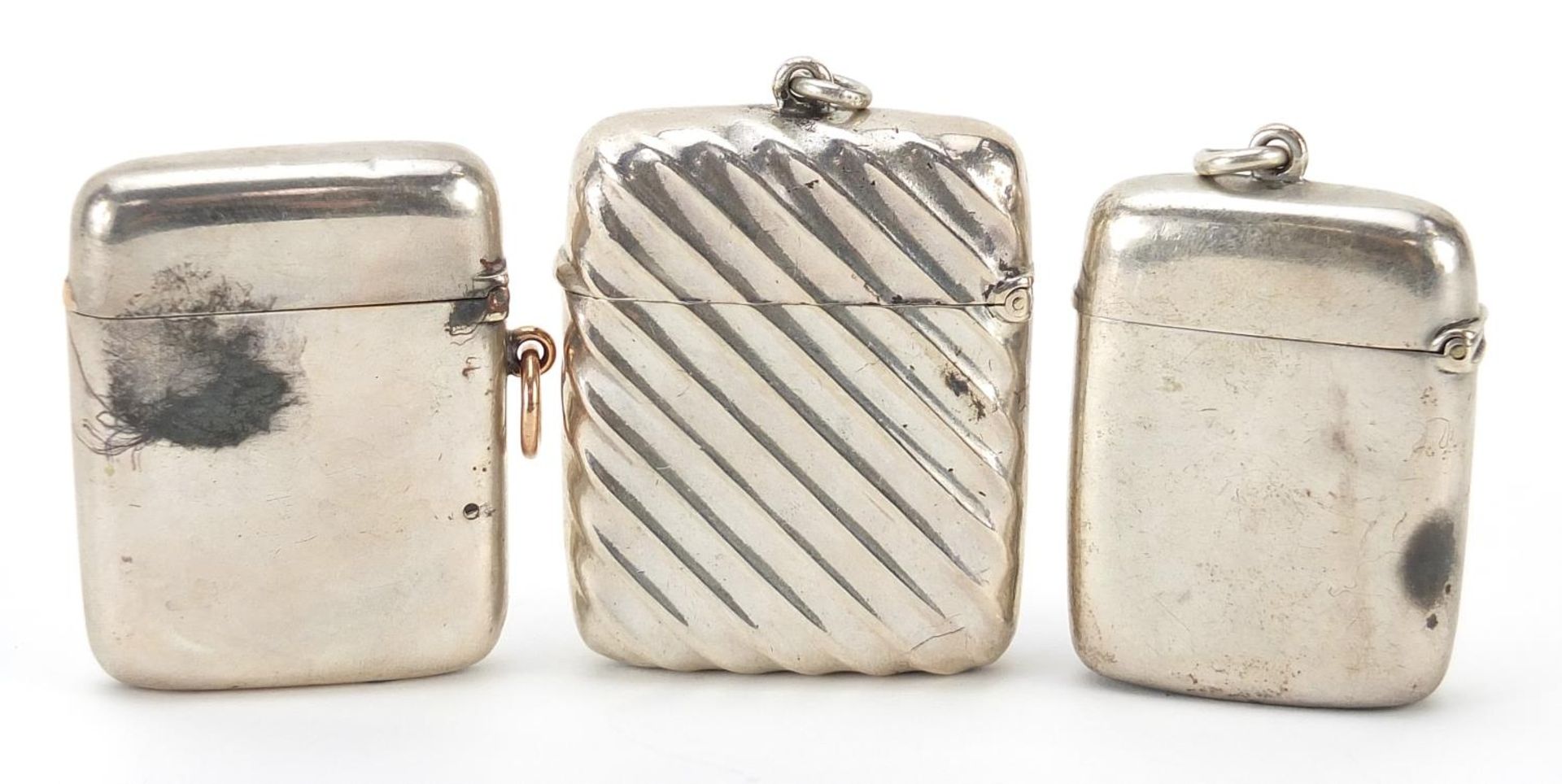 Three Victorian and later silver vestas, one embossed, the largest 5.5cm high, total weight 90.8g