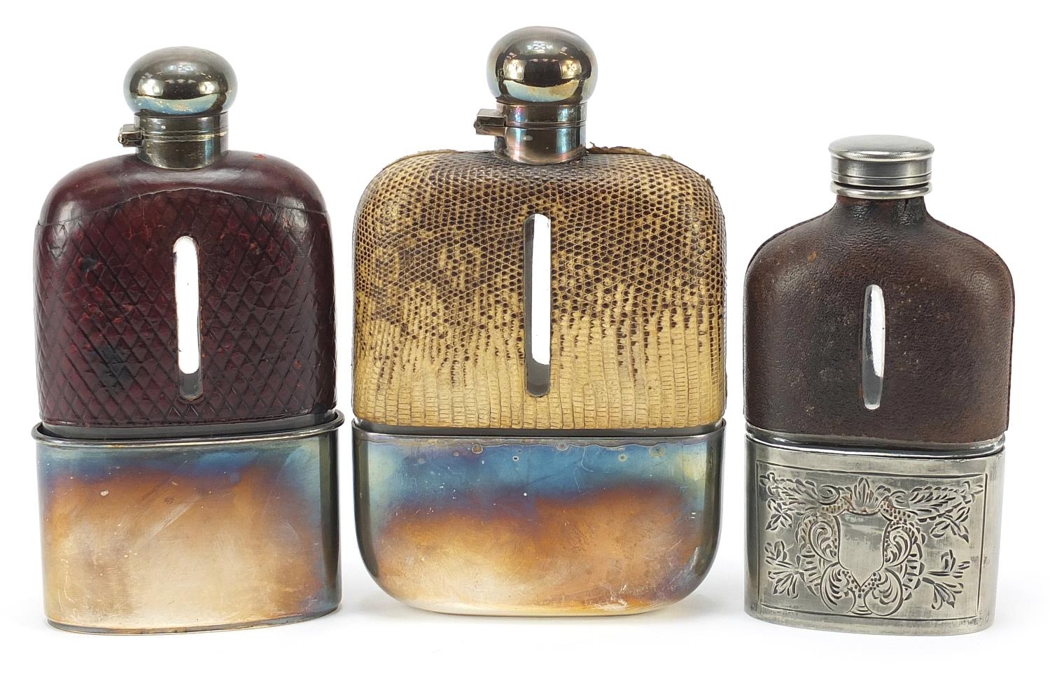 Three antique glass hip flasks with silver plated, snake skin and leather mounts, the largest 18cm