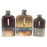 Three antique glass hip flasks with silver plated, snake skin and leather mounts, the largest 18cm