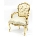 French style gilt framed open armchair with cream and gold upholstery, 91cm high