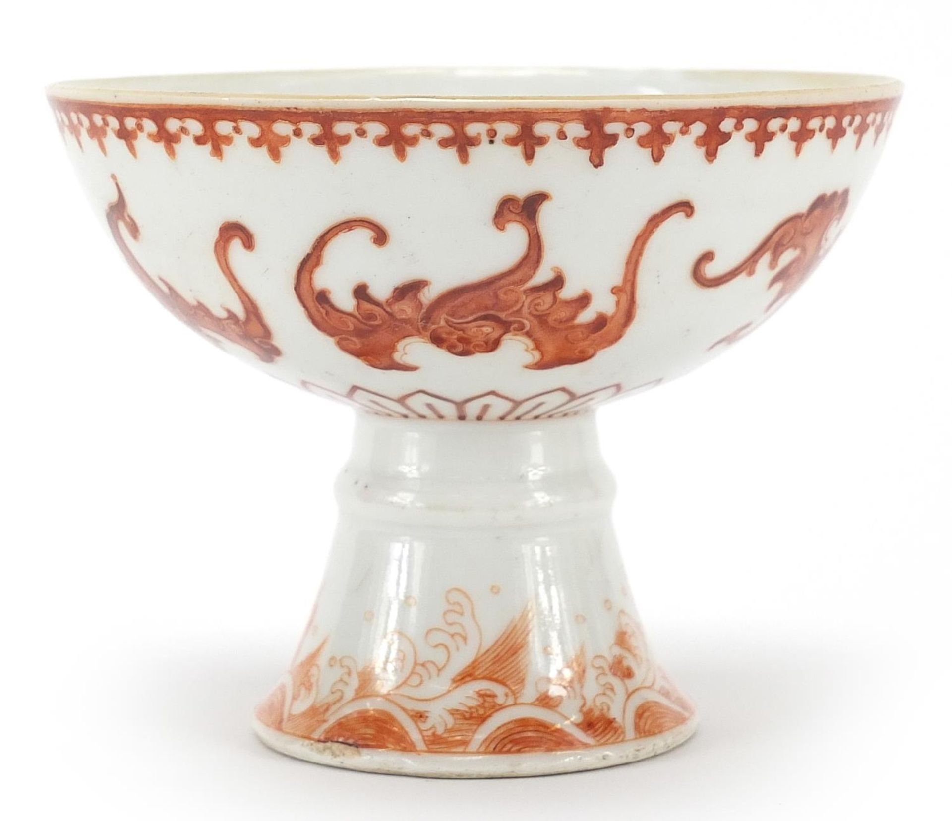 Chinese porcelain stem bowl hand painted in iron red with bats and crashing waves, six figure