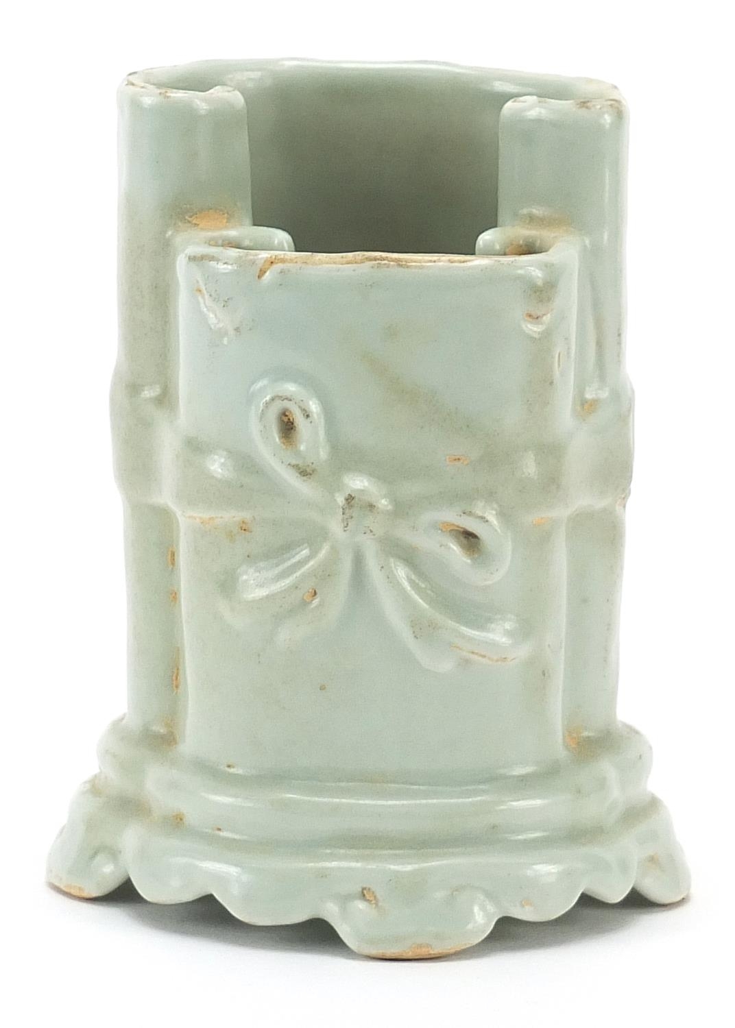 Chinese porcelain brush pot in the form of two scrolls having a celadon glaze, 10cm high