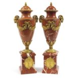 Large pair of French Empire style rouge marble urns with gilt bronze rams head handles and mounts,