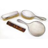 Elizabeth II silver four piece dressing table set including hand mirror and two brushes, London