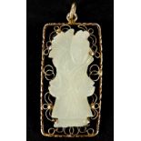 Chinese silver gilt pendant housing a pale green jade panel carved with a figure, 4cm high, 8.2g