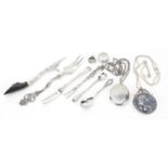 Silver jewellery and objects including locket with necklace, forks, letter opener and a Churchill