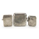 Three Edwardian and later silver vestas with engraved decoration, the largest 5.5cm wide, total