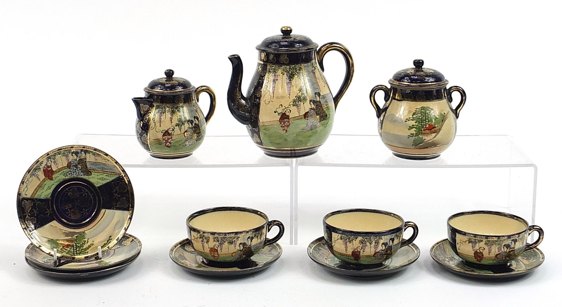 Japanese Satsuma part tea service including teapot, sugar bowl and milk jug, the teapot 16cm high