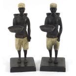 Pair of cold painted bronze figures of African slaves, each 25.5cm high