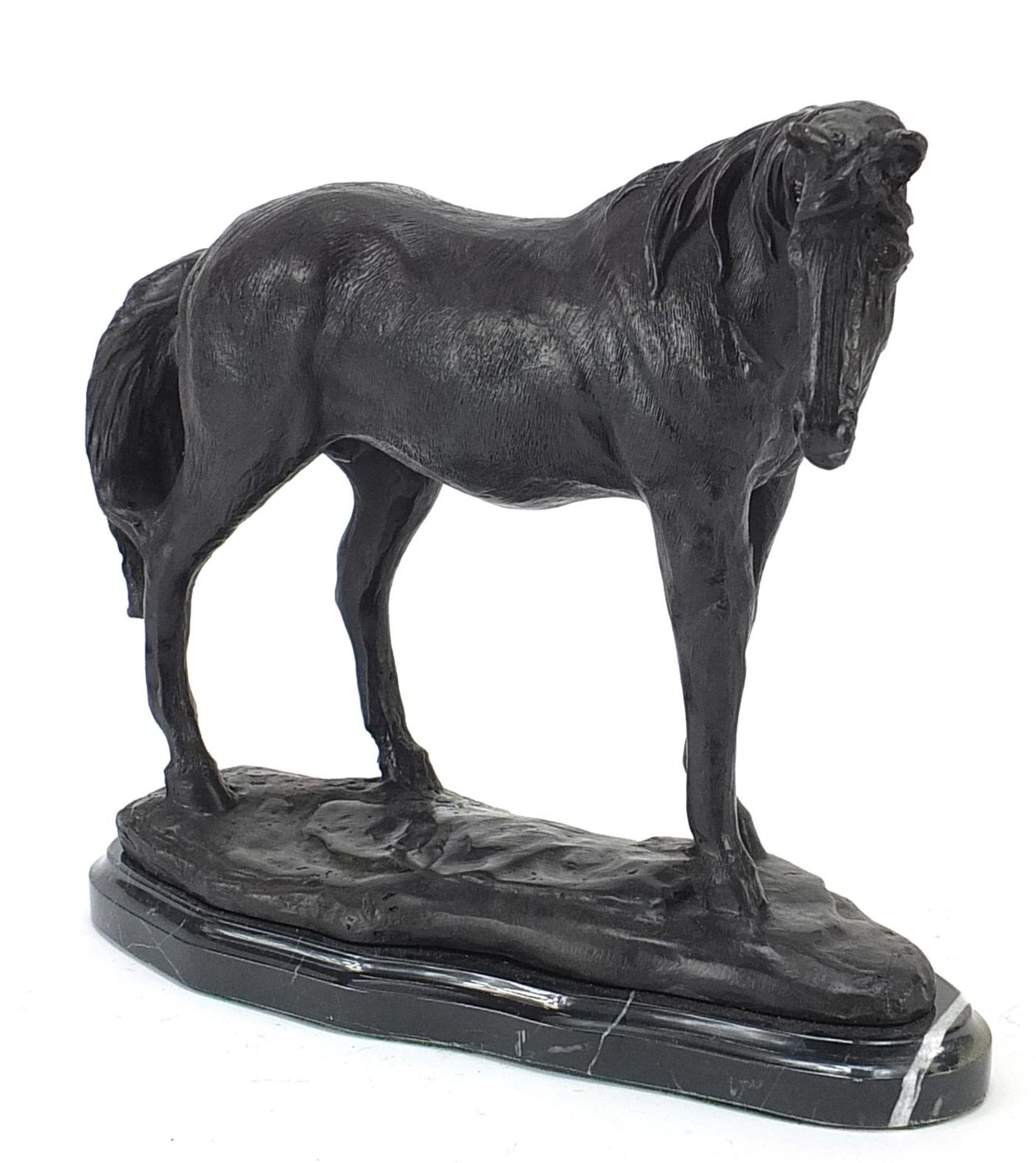 Patinated bronze horse raised on a black marble base, 26cm in length