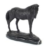 Patinated bronze horse raised on a black marble base, 26cm in length