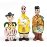 Three novelty porcelain figural decanters comprising scotch, vodka and Bourbon, the largest 30cm