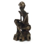 Chinese patinated bronze figure of a seated skeleton man, 21.5cm high