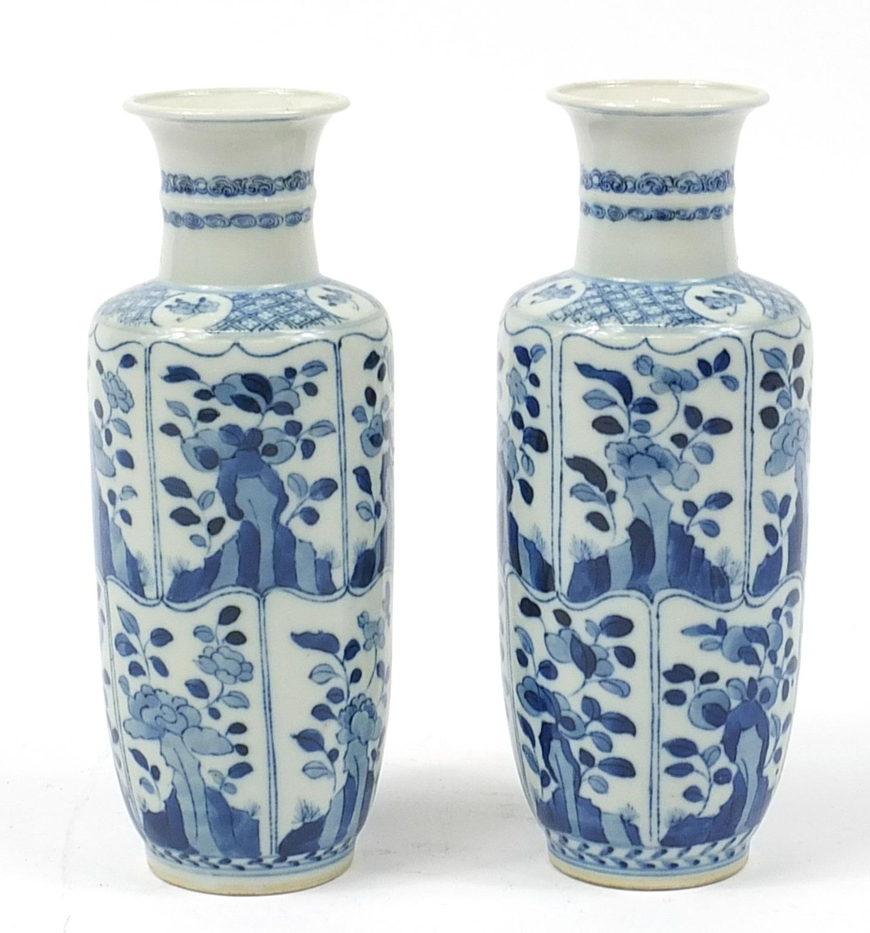 Pair of Chinese blue and white porcelain vases hand painted with panels of flowers, Kangxi blue ring