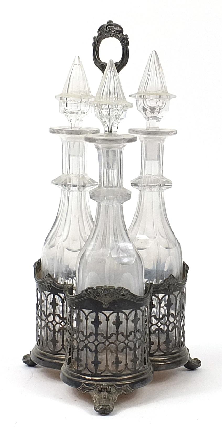 Three cut glass decanters housed in a silver plated tantalus, 42cm high