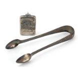 Victorian silver stamp case with gilt interior and a pair of silver sugar tongs, the stamp case