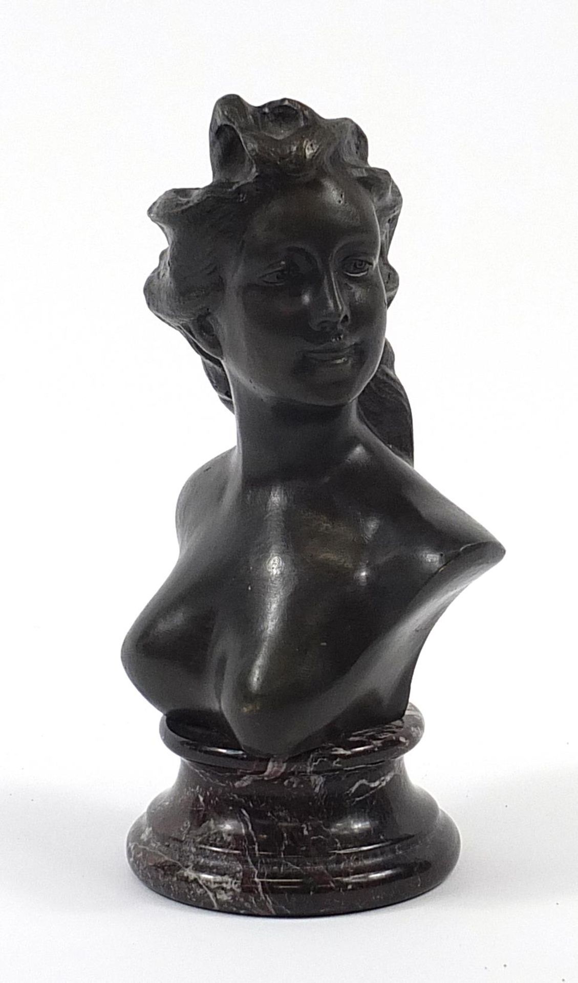 Patinated bronze bust of a nude Art Nouveau female raised on a variegated marble base, 25cm high