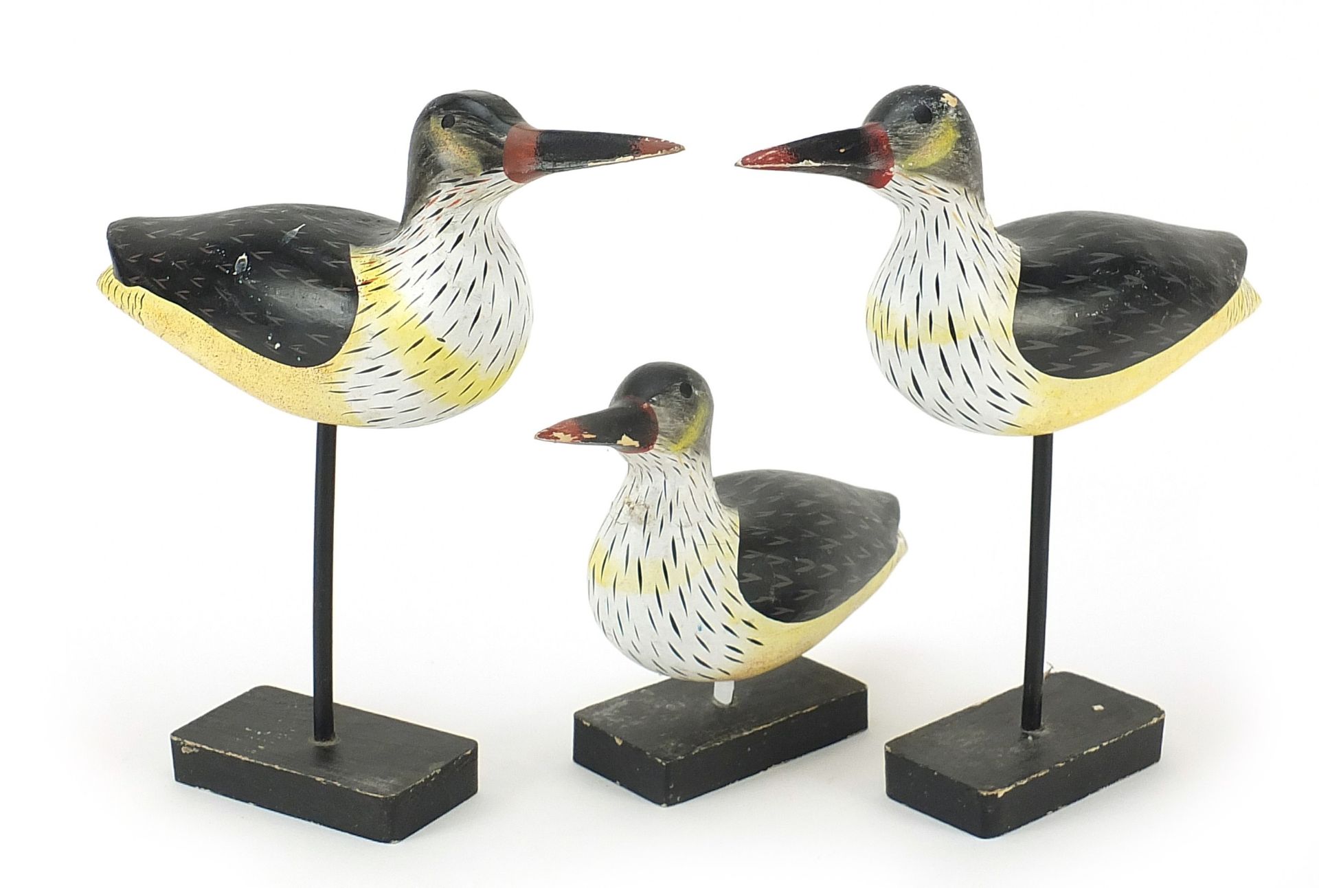 Manner of Guy Taplin, three hand painted carved wood birds on stands, the largest 25.5cm high