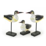 Manner of Guy Taplin, three hand painted carved wood birds on stands, the largest 25.5cm high