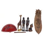 African and tribal wood carvings including a large wall mask and pair of ebony figures, the