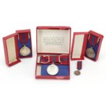 Three Elizabeth II 1953 Coronation medals and a miniature with boxes including a ladies issue