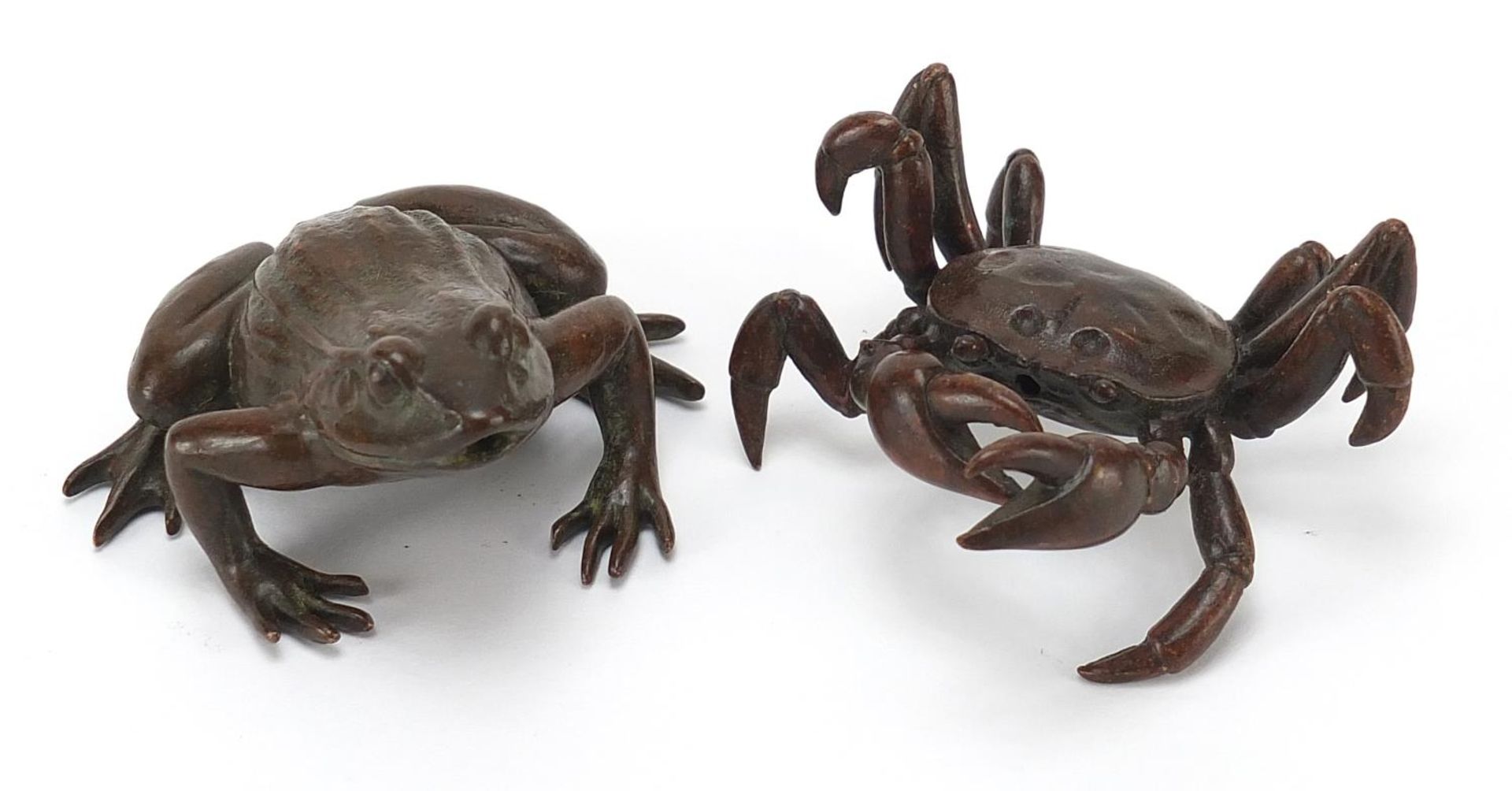 Two Japanese patinated bronze animals comprising frog and crab, each with impressed marks, the