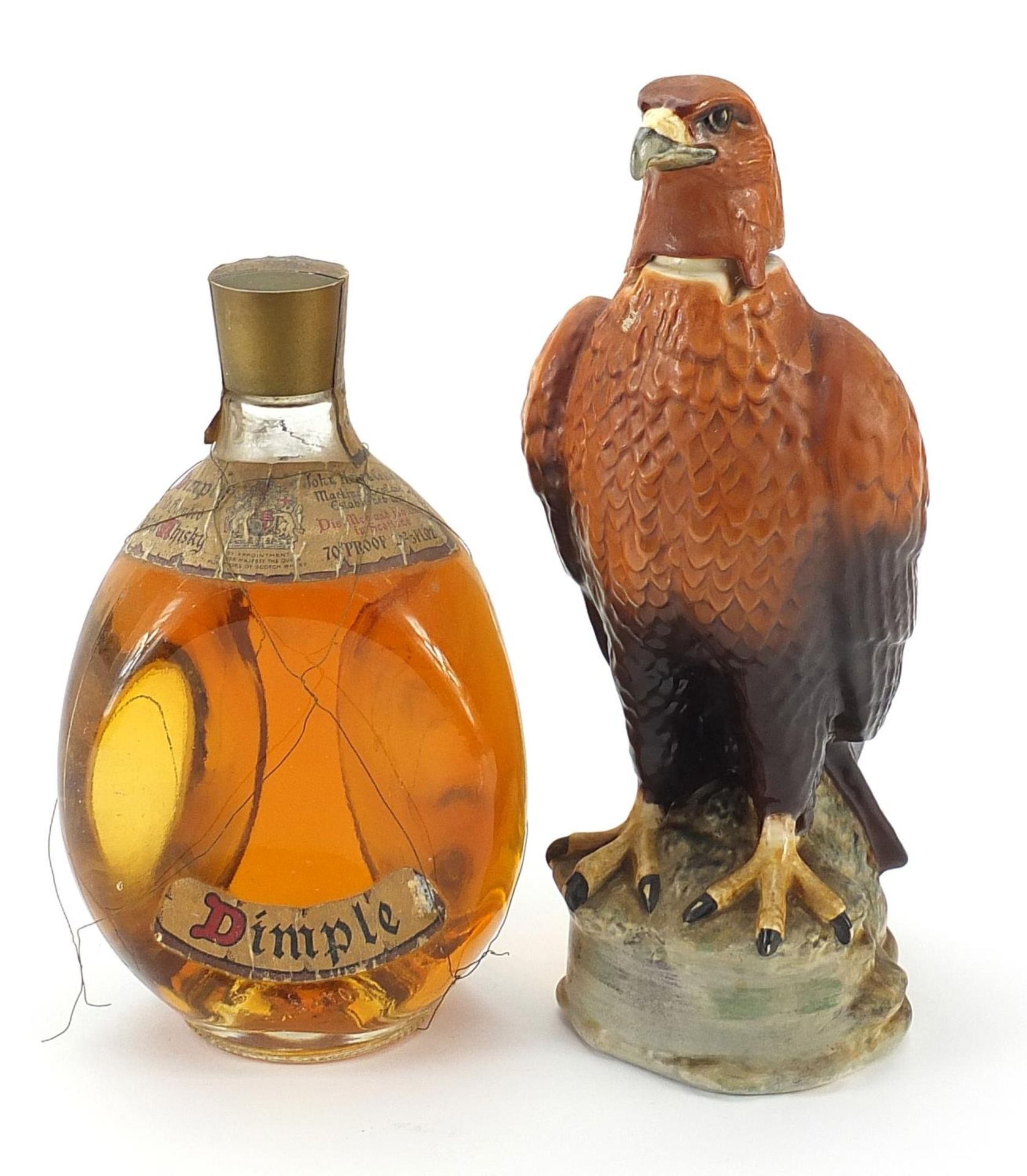 Bottle of Haig Dimple Scotch whiskey and a Beswick Golden Eagle decanter