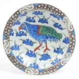 Turkish Iznik pottery plate hand painted with a bird amongst flowers, 33cm in diameter