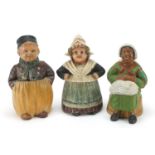 Three continental terracotta figural tobacco jars and covers, one impressed J M to the base, the