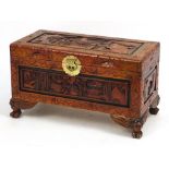 Chinese camphor wood trunk carved with figures in an interior, 39cm H x 69cm W x 34cm D