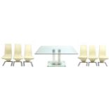 Contemporary chrome and glass dining table and six chairs with cream faux leather upholstery, the