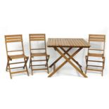 Folding teak garden table and three chairs, the table 100cm H x 90cm W x 90cm D